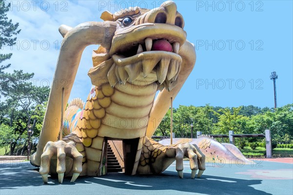 Playground equipment in the shape of a large dragon under a blue sky, in Ulsan, South Korea, Asia