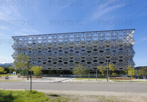 Reutlingen University, Reutlingen University, Texoversum, German University Building Award 2024 for TEXOVERSUM, modern architecture, facade made of carbon and glass fibres, mesh, innovative, identity-creating, unique facade, campus, place of learning, special, extraordinary new building for textile courses, light, airy, airy, holes, architectural eye-catcher, university campus, lights, street, young trees, blue sky, Reutlingen, Baden-Wuerttemberg, Germany, Europe