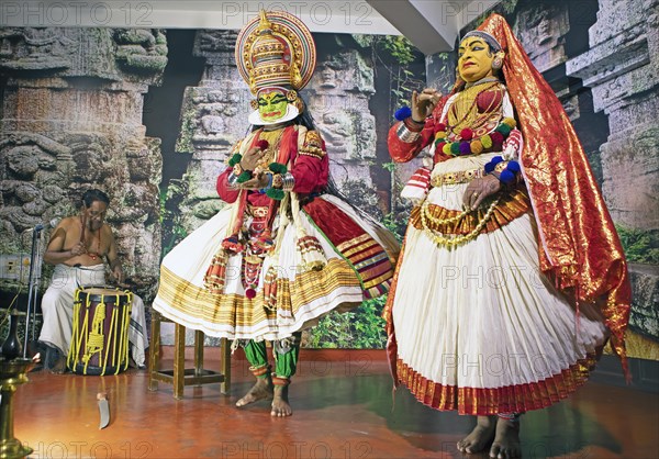 Kathakali performer or mime, 38 and 60 years old, and drummer on stage at the Kochi Kathakali Centre, Kochi, Kerala, India, Asia