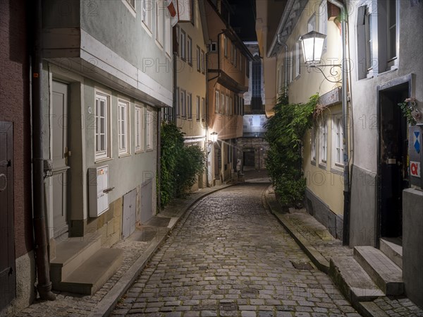 Narrow alley with cobblestones in the historic old town at dusk, Schwaebisch Hall, Hohenlohe, Baden-Wuerttemberg, Germany, Europe