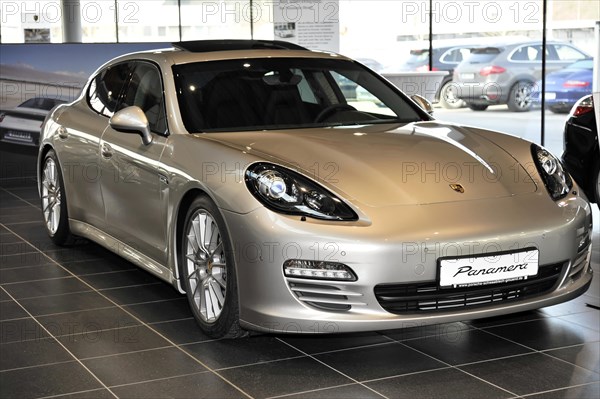 Silver Porsche Panamera in a showroom of a car dealership, Schwaebisch Gmuend, Baden-Wuerttemberg, Germany, Europe