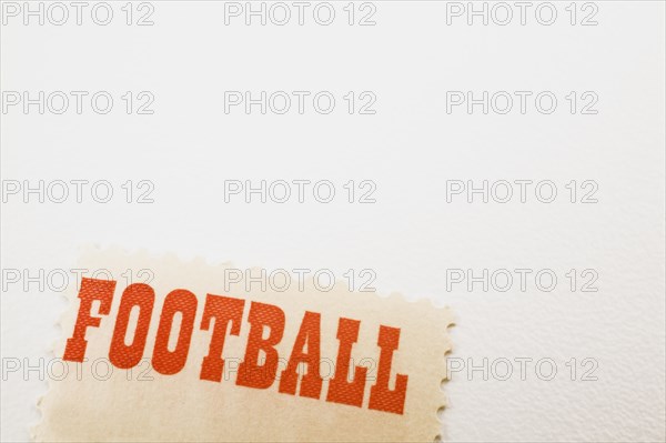 Close-up of the word Football printed in bold red letters on commemorative postage stamp on white background, Studio Composition, Quebec, Canada, North America