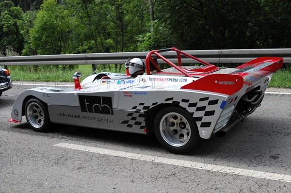 A white and red racing car with sponsor logos drives along a country road, SOLITUDE REVIVAL 2011, Stuttgart, Baden-Wuerttemberg, Germany, Europe