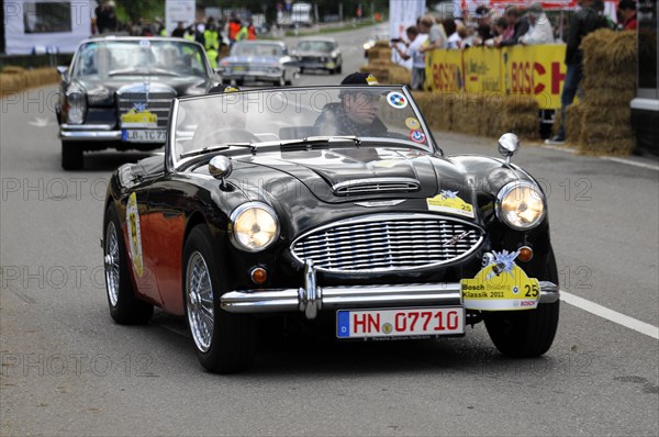 A black Austin-Healey sports car drives on a road at a classic car race, SOLITUDE REVIVAL 2011, Stuttgart, Baden-Wuerttemberg, Germany, Europe
