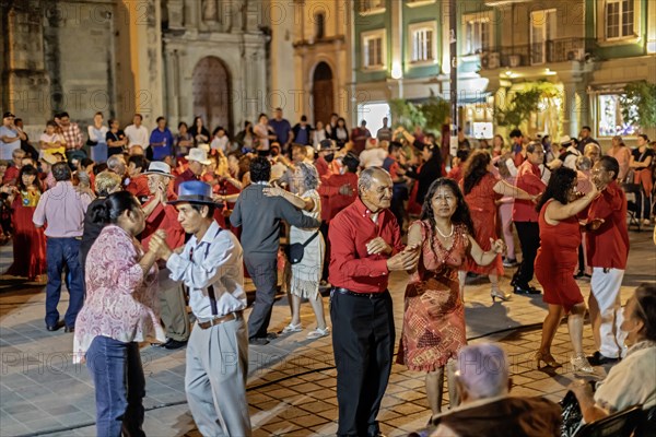 Oaxaca, Mexico, The weekly Wednesday dance in the zocalo, or central square. This night the dance was on Valentine's Day, with many dancers wearing red, Central America