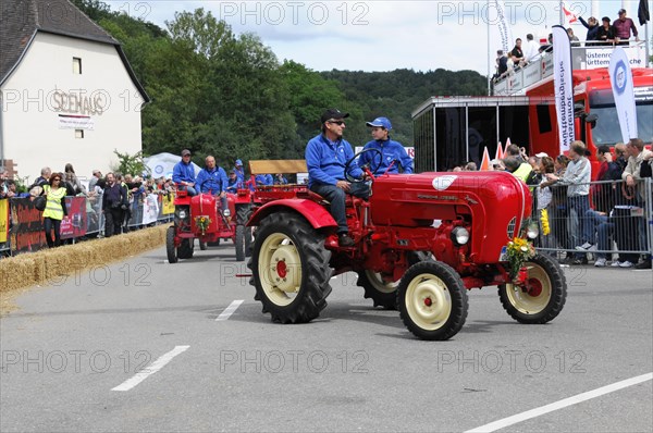 Porsche diesel tractors, drivers in blue present their red vintage tractors at a street festival, SOLITUDE REVIVAL 2011, Stuttgart, Baden-Wuerttemberg, Germany, Europe