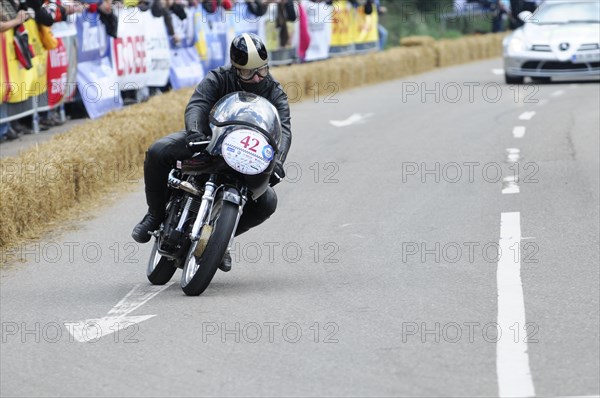A motorbike racer concentrates on the race track, spectators in the background, SOLITUDE REVIVAL 2011, Stuttgart, Baden-Wuerttemberg, Germany, Europe