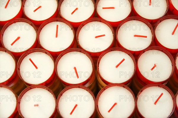Church of Notre-Dame de la Garde, Marseille, Several white candles in red containers form an orderly group, Marseille, Departement Bouches du Rhone, Region Provence Alpes Cote d'Azur, France, Europe