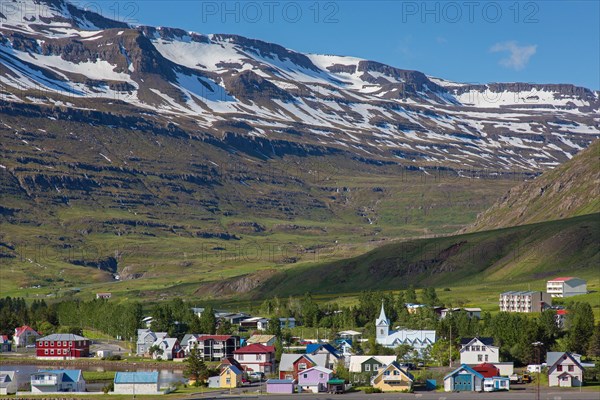 View over church and colourful houses in the town Seyoisfjoerour along the fjord Seydisfjoerdur in summer, Eastern Region, Austurland, Iceland, Europe
