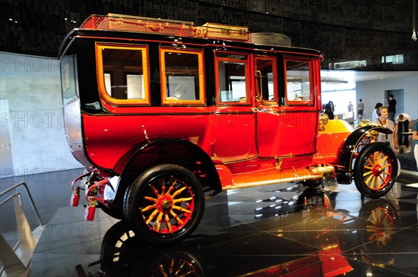 Historic red Mercedes-Benz bus from the early years of motor vehicle construction, Mercedes-Benz Museum, Stuttgart, Baden-Wuerttemberg, Germany, Europe