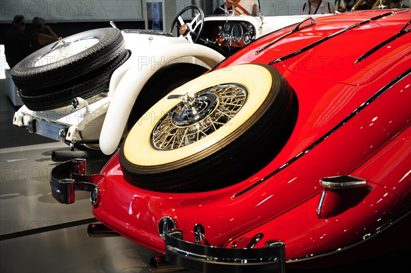 Museum, Mercedes-Benz Museum, Stuttgart, Side view of a red and white classic car with distinctive spoked wheels, Mercedes-Benz Museum, Stuttgart, Baden-Wuerttemberg, Germany, Europe