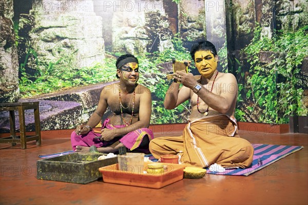 Kathakali performers or mime artists, 38 and 60 years old, make up their faces, Kochi Kathakali Centre, Kochi, Kerala, India, Asia