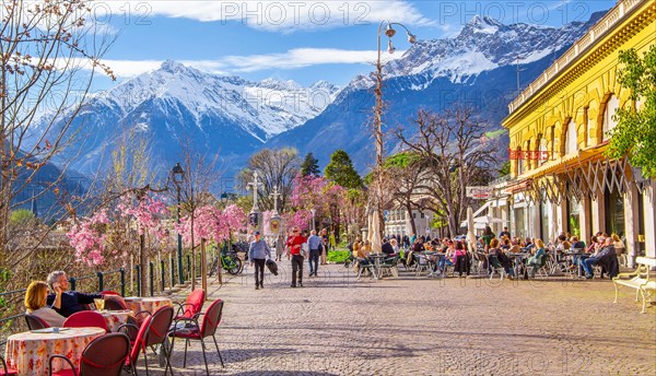 Winter promenade along the Passer with street cafe in the background the Texel Group with the peak 3006m in spring, Merano, Pass Valley, Adige Valley, Burggrafenamt, Alps, South Tyrol, Trentino-South Tyrol, Italy, Europe