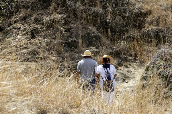 San Pablo Huitzo, Oaxaca, Mexico, Farmers are part of a cooperative that uses agroecological principles. They avoid pesticides and other chemicals, and recycle nutrients through the use of organic fertilizers. Hilario Roberto Gonzalez and Magdalena Balbina Avendano Ruiz walk on a trail near their farm, Central America