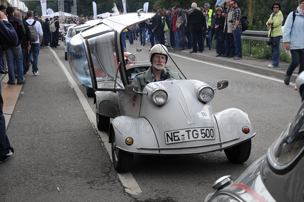 Small white car with a driver in a helmet, spectators line the road, SOLITUDE REVIVAL 2011, Stuttgart, Baden-Wuerttemberg, Germany, Europe