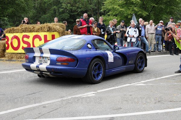A blue sports car with a racing number and white stripes drives along a race track with spectators, SOLITUDE REVIVAL 2011, Stuttgart, Baden-Wuerttemberg, Germany, Europe