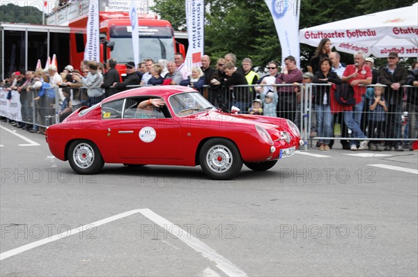 A red vintage car during a rally on the race track in front of spectators, SOLITUDE REVIVAL 2011, Stuttgart, Baden-Wuerttemberg, Germany, Europe