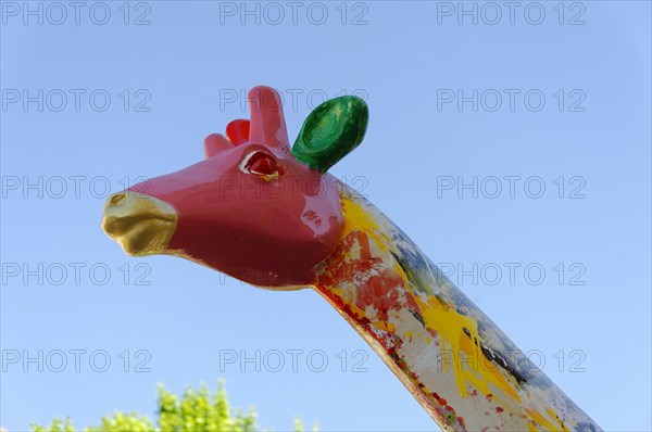 Head of a colourful giraffe statue in front of a clear blue sky, Marseille, Departement Bouches-du-Rhone, Provence-Alpes-Cote d'Azur region, France, Europe