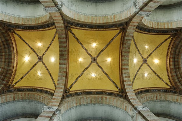 Marseille Cathedral or Cathedrale Sainte-Marie-Majeure de Marseille, 1852-1896, Marseille, View through the nave of a church with pews and various flags on the pillars, ceiling view with ornate paintings and lighting showing a symmetrical pattern, Marseille, Departement Bouches du Rhone, Region Provence Alpes Cote d'Azur, France, Europe