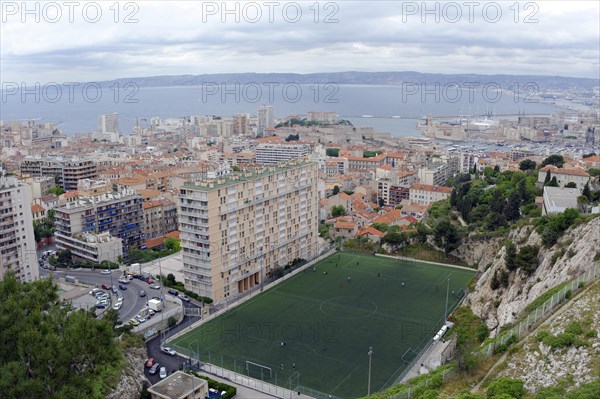 Marseille, panoramic view of a city with harbour, football pitch and high-rise buildings by the sea, Marseille, Departement Bouches-du-Rhone, Region Provence-Alpes-Cote d'Azur, France, Europe