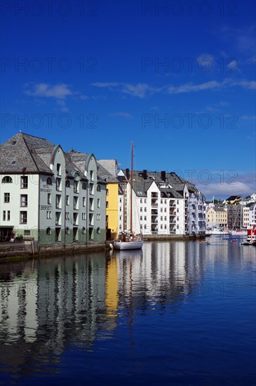 Houses reflected in the calm waters of a harbour, Art Nouveau, Kaiser Wilhelm II, Alesund, Norway, Europe