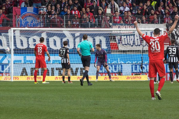 Football match, Eren DINKCI 1.FC Heidenheim not in the picture just scored the 1 to 1 equaliser against Borussia from Moenchengladbach, goalkeeper Moritz NICOLAS Borussia Moenchengladbach Mitte has the go-ahead with Norman THEUERKAUF 1.FC Heidenheim holding his arms up victoriously, Voith-Arena football stadium, Heidenheim