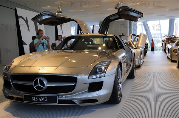 Museum, Mercedes-Benz Museum, Stuttgart, Silver Mercedes-Benz SLS AMG with open gullwing doors in a car exhibition, Mercedes-Benz Museum, Stuttgart, Baden-Wuerttemberg, Germany, Europe