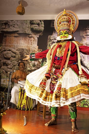 Kathakali performer or mime, 38 years old, and drummer on stage at the Kochi Kathakali Centre, Kochi, Kerala, India, Asia