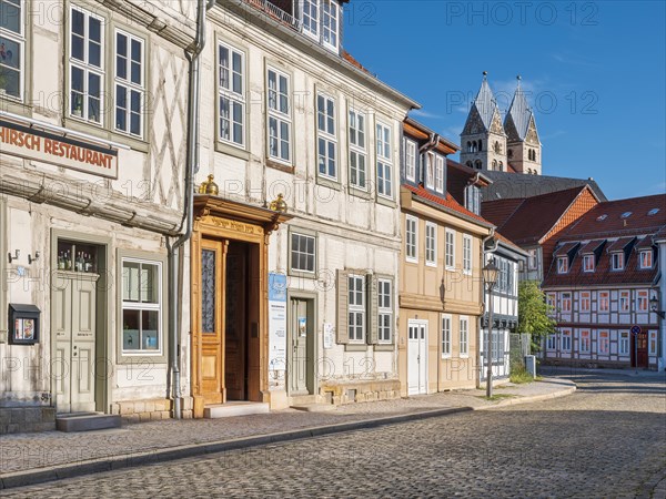 Street with half-timbered houses and cobblestones at the Jewish museum in the historic old town, in the background the towers of the Church of Our Dear Lady, Halberstadt, Saxony-Anhalt, Germany, Europe