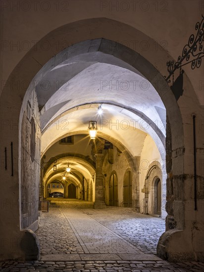 Inner courtyard in the Gothic part of the town hall at night, portal and passageway with lanterns, Rothenburg ob der Tauber, Middle Franconia, Bavaria, Germany, Europe