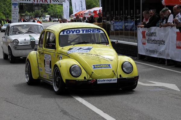 A yellow Volkswagen Beetle racing car with sponsor stickers drives past spectators, SOLITUDE REVIVAL 2011, Stuttgart, Baden-Wuerttemberg, Germany, Europe