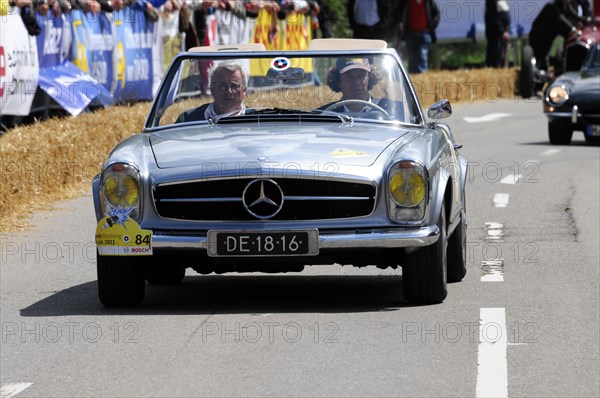 A silver Mercedes-Benz 300SL Roadster racing in front of a dense crowd of spectators, SOLITUDE REVIVAL 2011, Stuttgart, Baden-Wuerttemberg, Germany, Europe