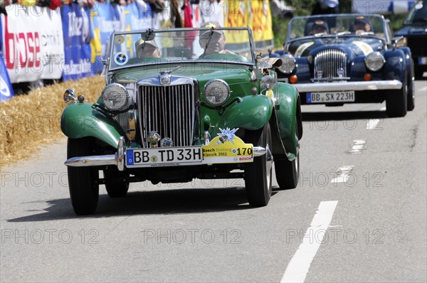 A green MG vintage car at a road race, surrounded by spectators, SOLITUDE REVIVAL 2011, Stuttgart, Baden-Wuerttemberg, Germany, Europe