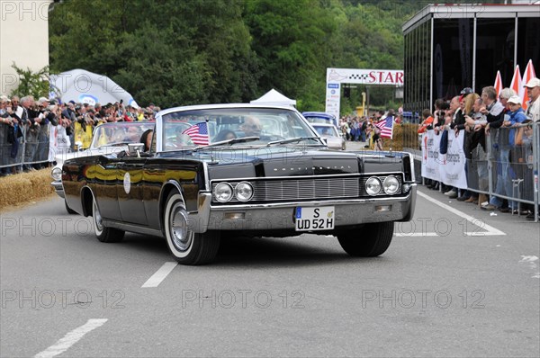 Black American convertible classic car with US flag in front of spectators, SOLITUDE REVIVAL 2011, Stuttgart, Baden-Wuerttemberg, Germany, Europe