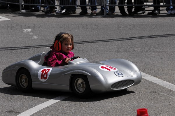 A child in a silver soapbox experiences the feeling of racing in front of spectators, SOLITUDE REVIVAL 2011, Stuttgart, Baden-Wuerttemberg, Germany, Europe