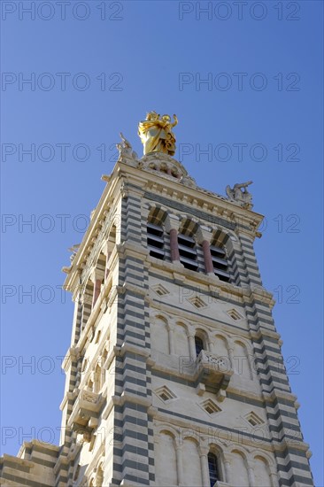 Church of Notre-Dame de la Garde, Marseille, Tower of a church with golden sculptures in front of a blue sky, Marseille, Departement Bouches du Rhone, Region Provence Alpes Cote d'Azur, France, Europe