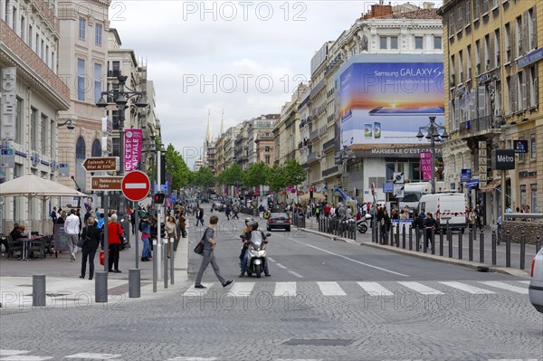 Marseille, A busy city street with people crossing the road and urban architecture, Marseille, Departement Bouches-du-Rhone, Provence-Alpes-Cote d'Azur region, France, Europe