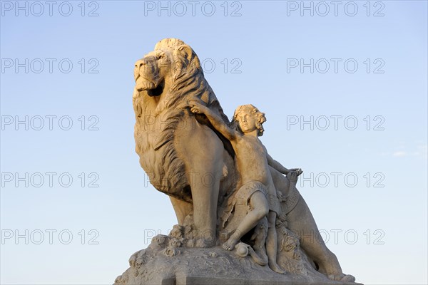 Statue of a lion with a figure against a blue sky, Marseille, Departement Bouches-du-Rhone, Region Provence-Alpes-Cote d'Azur, France, Europe