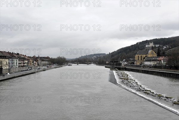 Wuerzburg, Cloudy cityscape with river and bridge, surrounded by trees and buildings on the bank, Wuerzburg, Lower Franconia, Bavaria, Germany, Europe
