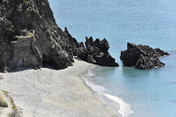 Beach at Solabrena, Small bay with a pebble beach and black rocks in summer, Andalusia, Spain, Europe