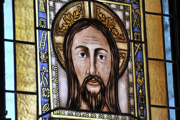 Castillo de Santa Catalina in Jaen, stained glass window showing Jesus with a serious facial expression and symbolic decorations, Granada, Andalusia, Spain, Europe
