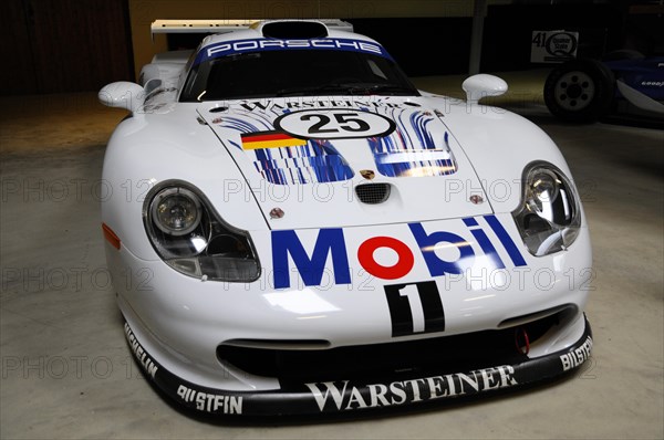 Deutsches Automuseum Langenburg, A white Porsche racing car with stickers and number 25 in a garage, Deutsches Automuseum Langenburg, Langenburg, Baden-Wuerttemberg, Germany, Europe