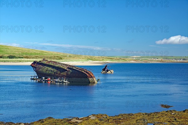Parts of sunken ships sticking out of the water, Churchill Barriers, 2nd World War, Orkney Islands, Scotland, UK