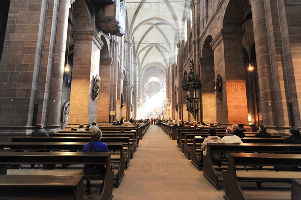 Speyer Cathedral, rays of light fall on visitors in the interior of Worms Cathedral, Speyer Cathedral, Unesco World Heritage Site, foundation stone laid around 1030, Speyer, Rhineland-Palatinate, Germany, Europe