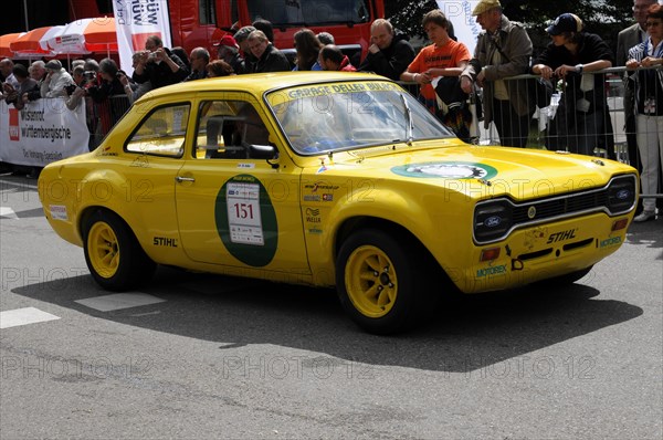 A yellow vintage car with a racing number drives along in front of spectators during a race, SOLITUDE REVIVAL 2011, Stuttgart, Baden-Wuerttemberg, Germany, Europe