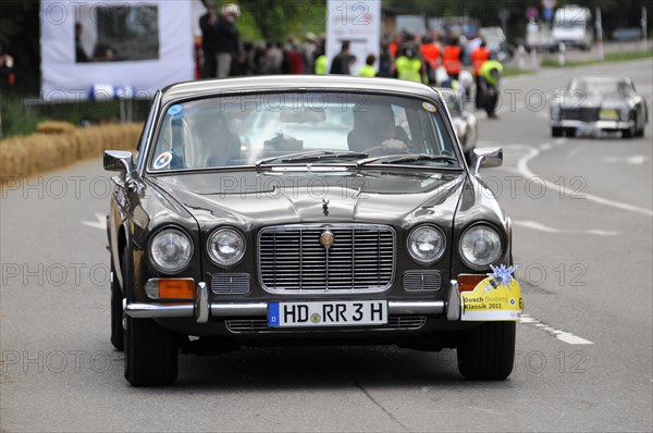 A black Jaguar classic car drives past spectators at a car race, SOLITUDE REVIVAL 2011, Stuttgart, Baden-Wuerttemberg, Germany, Europe