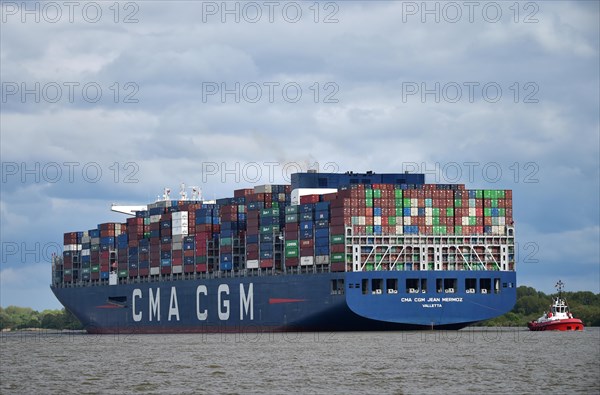 Container ship CMA CGM Jean Mermoz sailing in the Elbe to the port of Hamburg, Germany, Europe