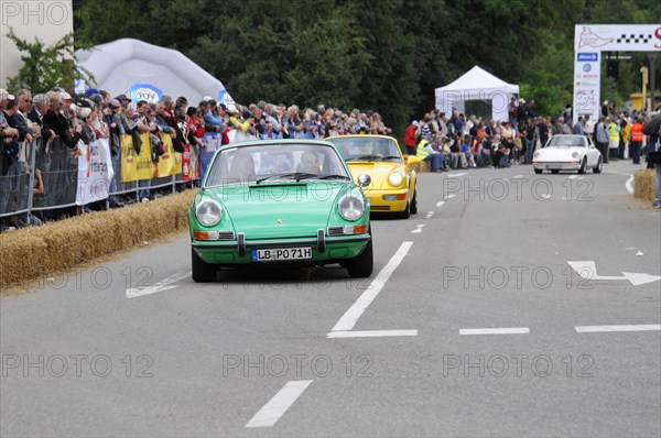 A green Porsche 911 drives on a street during an event, SOLITUDE REVIVAL 2011, Stuttgart, Baden-Wuerttemberg, Germany, Europe