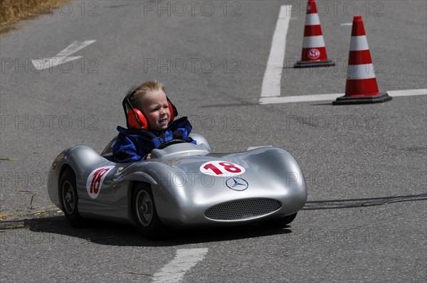 A child in a silver soapbox racing car with the number 18 drives past pylons, SOLITUDE REVIVAL 2011, Stuttgart, Baden-Wuerttemberg, Germany, Europe
