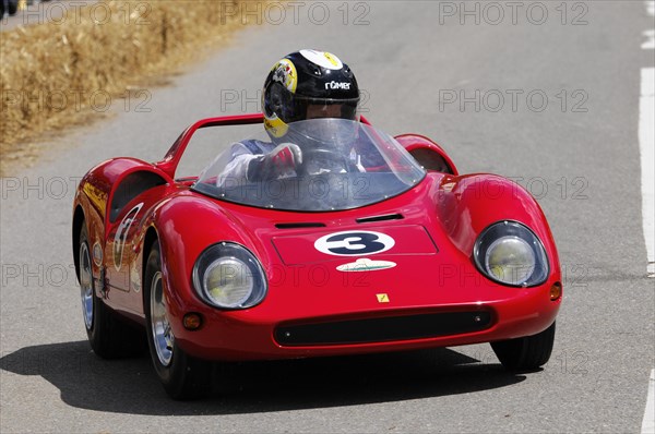 Intensely focussed driver in a bright red soapbox at high speed, SOLITUDE REVIVAL 2011, Stuttgart, Baden-Wuerttemberg, Germany, Europe